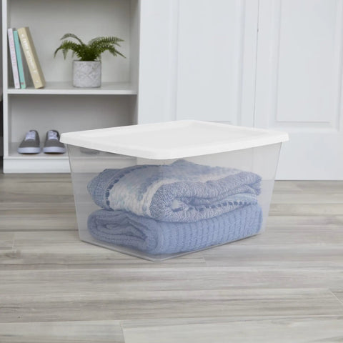 Built Tough 58 Quart Clear Plastic Storage Bin With Zero Sweat Snap Lock Lid, holding folded blue blankets for organized storage.