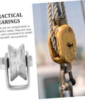 Heavy-duty cast-iron V-groove wheel pulley with rigid bracket; installed on a lifting rope.