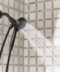 Shower running with Matte Black Three Point Five Inch Six Function Detachable Handheld Showerhead With Magnetic Docking System