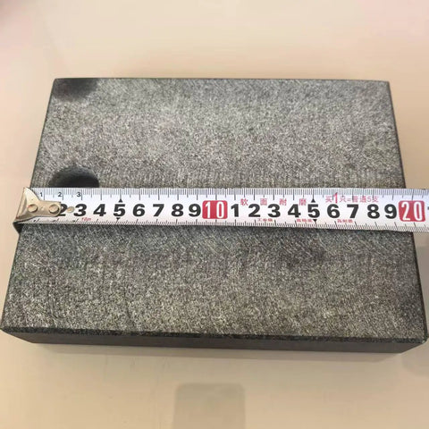 200 By 150 By 40 Millimeter Precision Granite Comparator Base with measuring tape on black granite surface