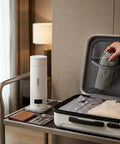 Premium No Sweat 500 Ml Portable Electric Kettle With Smart Temp Control displayed on a table next to a packed suitcase.
