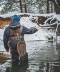 Fly Fishing Sling Pack For Quick Access Tackle Storage Shoulder Bag With Adjustable Padded Straps in use by angler in snowy river