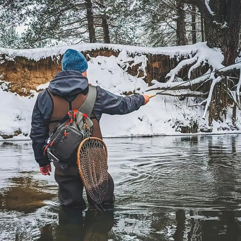 Fly Fishing Sling Pack For Quick Access Tackle Storage Shoulder Bag With Adjustable Padded Straps in use by angler in snowy river