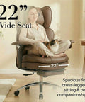 Woman sitting cross-legged with cat on Big and Tall Executive Desk Chair With Footrest, 400Lb Heavy Duty High Back PU Leather, Modern Ergonomic Reclining Computer Chair for Home Office, Comfortable Boss Style Brown.
