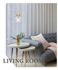 Gold Pendant Light With Clear Glass Shade Adjustable Height Modern Hanging Fixture in a cozy living room setting