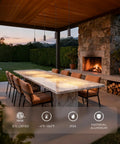 Outdoor dining area with Low Voltage 12V Hanging Landscape Lights 5CCT LED Outdoor Pendant Lighting illuminating a long table by a stone fireplace.