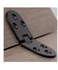 Close-up of black foldable hinge for cabinets, screw-on type, installed on wood panel, 180-degree swing, Set Of 2 Foldable Cabinet Hinges