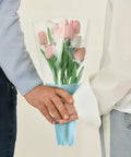 Couple holding a bouquet in 150 Pack Flower Bouquet Sleeves With Plastic OPP Wrapping Bags, DIY Friendly Protective Floral Packaging For Bouquets