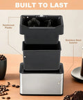 Electric Espresso Knock Box With Automatic Portafilter Cleaner for No Sweat Coffee Puck Disposal and Effortless Barista Counter Setup Perfect for Home Brews or Cafe Crews Today, showcasing stainless steel and plastic materials.