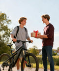 Two people outdoors with mountain bike, one holding a gift box, no clear connection to Two Pack Portable Bike Repair Stands With Flip Stand