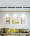 Living room with Six Pack LED Track Lighting Heads for single circuit H type rails illuminating art on a wall.