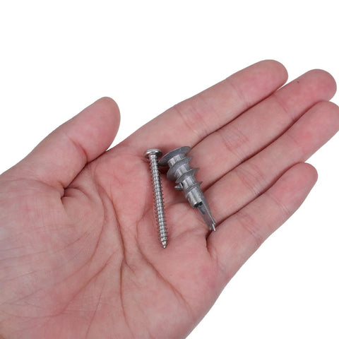 Close-up of Heavy Duty Zinc Alloy Drywall Anchor Kit With Self Drilling Screws 30 Pack in hand showing screw and anchor detail.