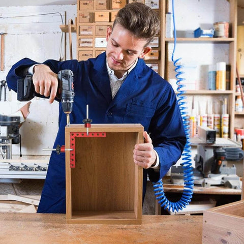 Man using Four Pack 5.5 Inch Corner Clamps for Woodworking, 90 Degree Right Angle Clamps with Aluminum Alloy Positioning Squares on a cabinet.