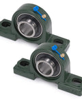 Two XIKE UCP206-18 pillow block bearings with 1-1/8 in bore on green cast-iron bases; chrome sealed, self-aligning.