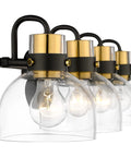 Close-up of Four Light Bathroom Vanity Wall Sconce Over Mirror With Clear Glass Shades Black Backplate And Brushed Gold Finish