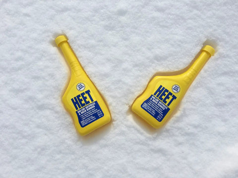 Water Removal and Gas Line Antifreeze for Winter Starts Keeps Your Fuel System Free of Water Prevents Gas Line Freezing and Rust Protection Plus Easy Starts in Cold Weather 12 Fl Oz yellow bottles on snow