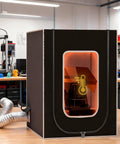 Vented Resin 3D Printer Enclosure With LED Light And Vent Kit in a workshop, showing clear front and side vent hose attached