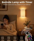 EZVALO Battery Operated Wall Sconce, Pleated Shades Wireless Wall Sconces Set of Two with Remote, 3 Color & 80 RGB Rechargeable Wall Lights, Dimmable, Timer, Wall Lamp for Bedroom (White 2Pack) in cozy bedroom setting with remote.