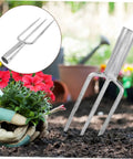 All In One Prong Head Fishing Fork And Garden Tool For Spearfishing Weeding And Digging with flowers and soil background