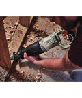 Using Heavy Duty 7.5 Amp Variable Speed Corded Reciprocating Saw to cut wood on a job site with ergonomic grip.