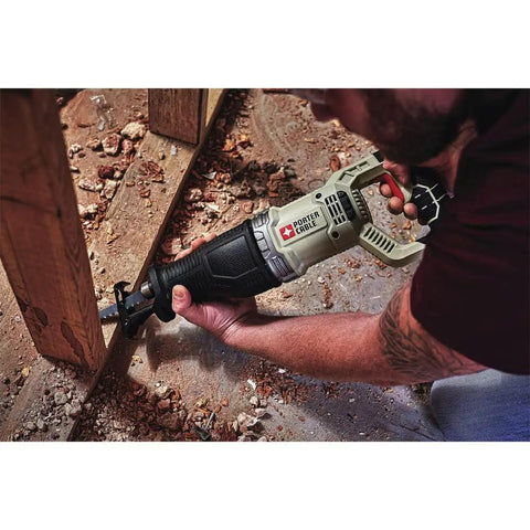 Using Heavy Duty 7.5 Amp Variable Speed Corded Reciprocating Saw to cut wood on a job site with ergonomic grip.