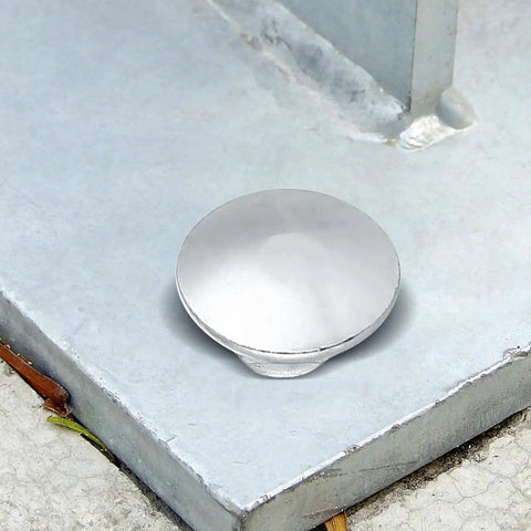 Close-up of a zinc-plated carriage bolt head on a concrete surface from the Carriage Bolt Kit Zinc Plated 20 Sets With Nuts And Washers.