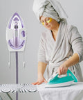 Woman ironing clothes with Heavy Duty 51.97 Inch High Temperature Steam Hose Replacement For Garment Steamer in background