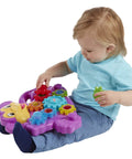 Child playing with Totally Awesome Dope Monkey Gears Stacking And Spinning Toy, colorful plastic cogs in hand.