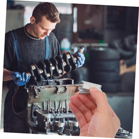 Mechanic working on engine crankshaft with hand holding a piece of 12-Piece Galvanized Steel Toggle Wing Bolts Kit For Drywall Anchors