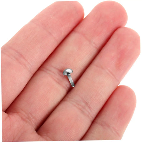 Close-up of a silver iron brad held in hand from 100 Pcs Diy Iron Brads For Puppet Making Kit Mini Fasteners For Kids Crafts Round Paper Tacks