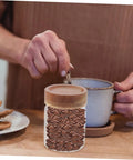 Close-up of 3 Piece Airtight Glass Canister Set designed for loose tea and spices with coffee beans visible inside.