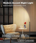 Arc Corner Floor Lamp With Curved LED Design And Touch Dimmer 3000K Warm White Glow Three Brightness Presets For Bedroom Or Living Room 63 Inch Tall 12W Black Modern Standing Lamp For Cozy Moody Vibes beside chair.