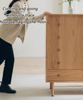 A person using Heavy Duty 24Pcs Furniture Sliders Moving Tools With Foam Pads for smooth gliding on a wooden cabinet.
