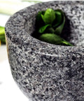 Granite Mortar And Pestle Set with herbs, showcasing 2 cup capacity and durable stone kitchen tool design.