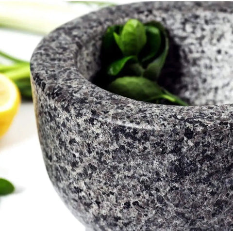 Granite Mortar And Pestle Set with herbs, showcasing 2 cup capacity and durable stone kitchen tool design.