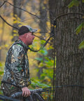 Hunter using Rope Style Tree Strap For Hunting Safety, 9 Foot Length, Durable Rope Attachment for secure tree stand setup.