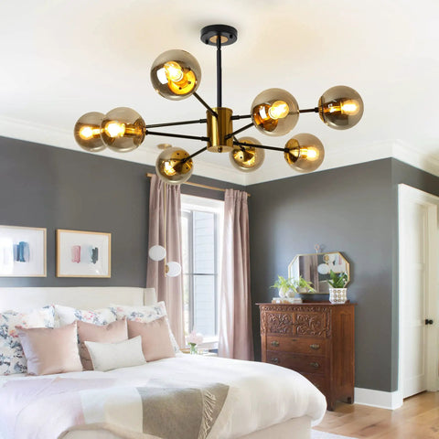 Modern 8 Light Glass Globe Sputnik Chandelier In Black And Gold E26 Base Crystal Pendant Light with Height Adjustable Arms installed in bedroom