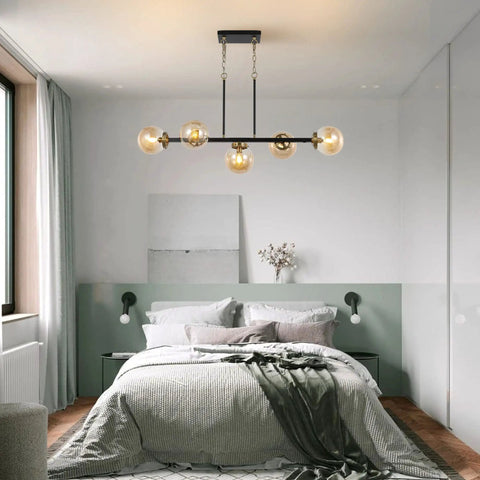 Bedroom setting with 5 Light Modern Sputnik Island Pendant Light Fixture With Amber Glass Globe Shades For Flat Or Sloped Ceilings Height Adjustable Chandelier Black.