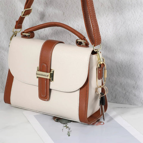 Tan and cream handbag with gold hardware, featuring the 16 Piece Locking Brass Carabiner Key Ring Set With Screw Lock Clips attached.