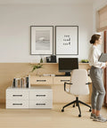 Home office with desk featuring matte black cabinet handles, modern decor, computer, and chair.
