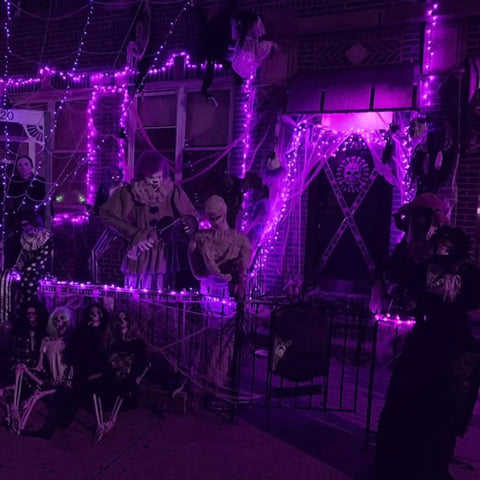 Two Pack 80Ft Solar Powered Fairy Lights With 240 LEDs Copper Wire, 8 Modes Waterproof Outdoor String Lights illuminating a festive porch in purple glow