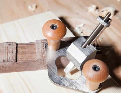 Router Plane Handheld Woodworking Tool With Stainless Steel Body And Gray Finish close-up on wooden work surface