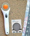 45mm Rotary Cutter Blades Pack Of 10 For DIY Quilting Sewing And Crafts and Fiskars cutter on cork with ruler