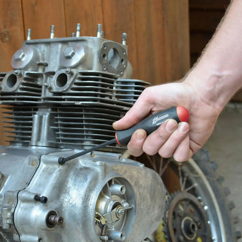 Person using Ergonomic Comfort Grip Balldriver Screwdrivers Set One And A Half To Five Millimeters Six Piece Professional Grade Durable Tools For Electronics Furniture And General Maintenance on motorcycle engine.