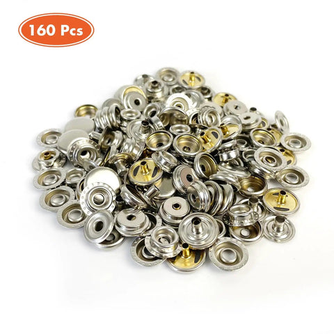 160 Piece Snap Button Kit With 15mm Marine Grade Snaps For Boat Covers Canvas Clothing And Leather Includes 40 Sockets 40 Caps 40 Male And 40 Female Snaps In A Clear Storage Box Brass Nickel Plated For DIYers. Assorted snap buttons in a pile showing brass and nickel details.