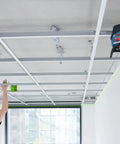 Pro Level 12V Green Beam Cross Line Laser With 100 Foot Reach And Smart Visimax Tech projecting green lines for accurate ceiling installation.