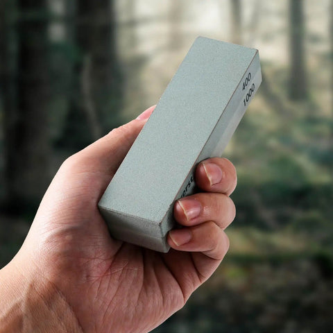 Hand holding Portable Whetstone Knife Sharpener with Dual Grit 400/1000 for On The Go Edge Repair