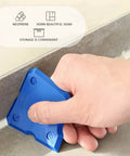 Using a blue tool from the 11 Piece Caulking Tool Kit With Sealant Finishing Tools to smooth caulk along a tile seam.