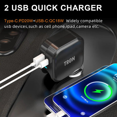 Game Changer 36W Fast Charger With Straight Up Dual Usb C And Universal Usb A Ports For Phones Tablets And Earbuds Compact Wall Car Adapter plugged into a surface with charging cables connected to a phone.