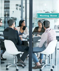 Office meeting room with people around a table, showing Clear Acrylic Name Plates With Adhesive Tapes Five Pack For Doors And Walls 2x8 Horizontal Name Plate Holder Office And Classroom Sign Frame Pro Grade For Easy Paper Insert Replacement.